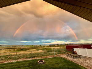 Yard at dusk with a fire pit and a view of countryside