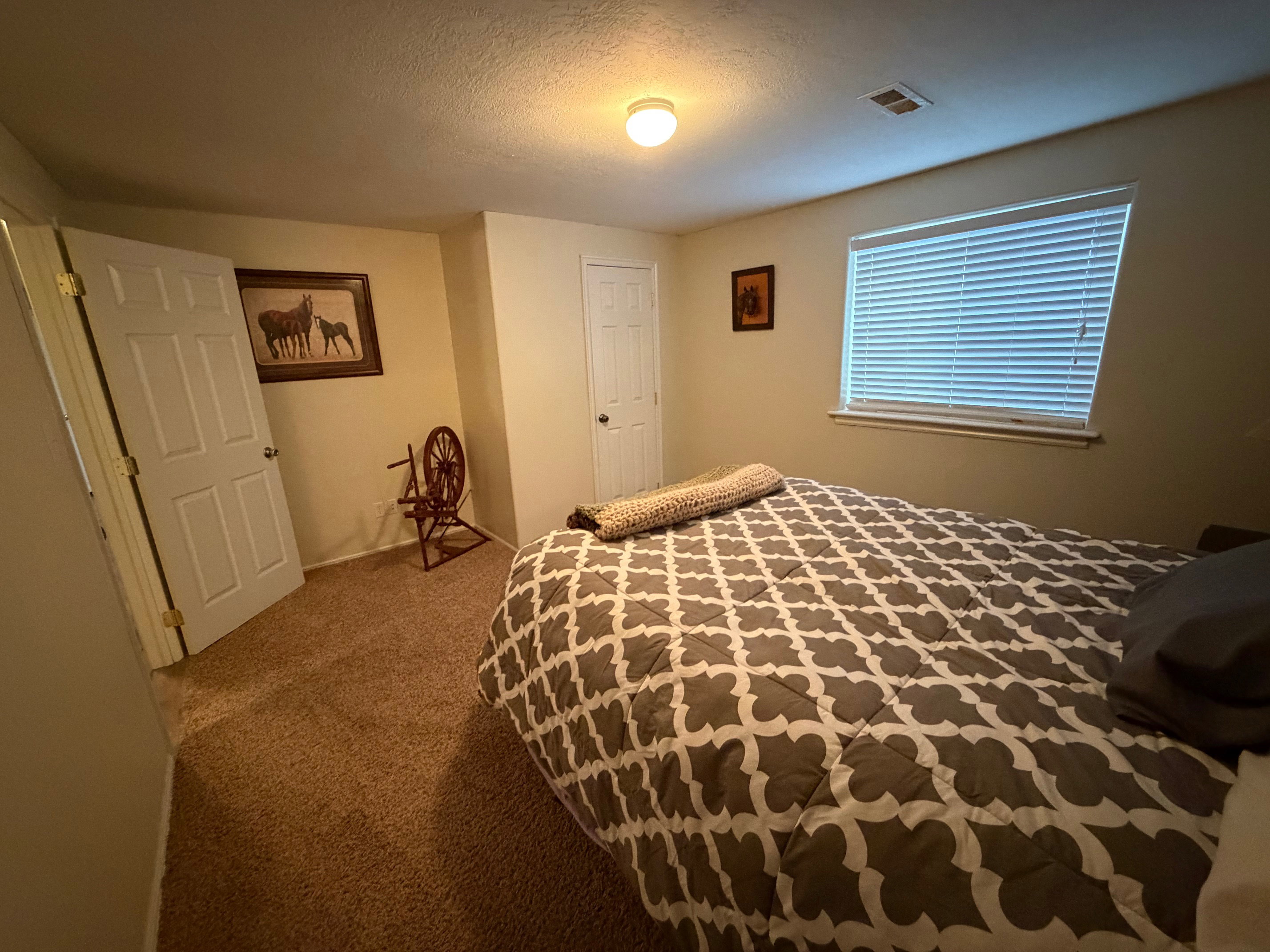 Carpeted bedroom with a textured ceiling