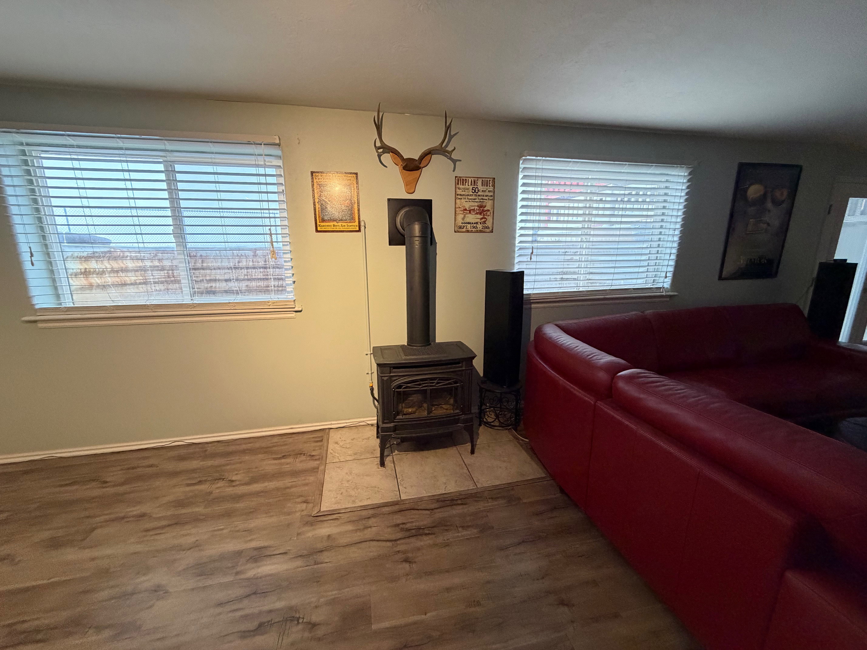 Living area with wood finished floors and a wood stove