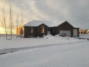 Ranch-style house featuring brick siding and an attached garage