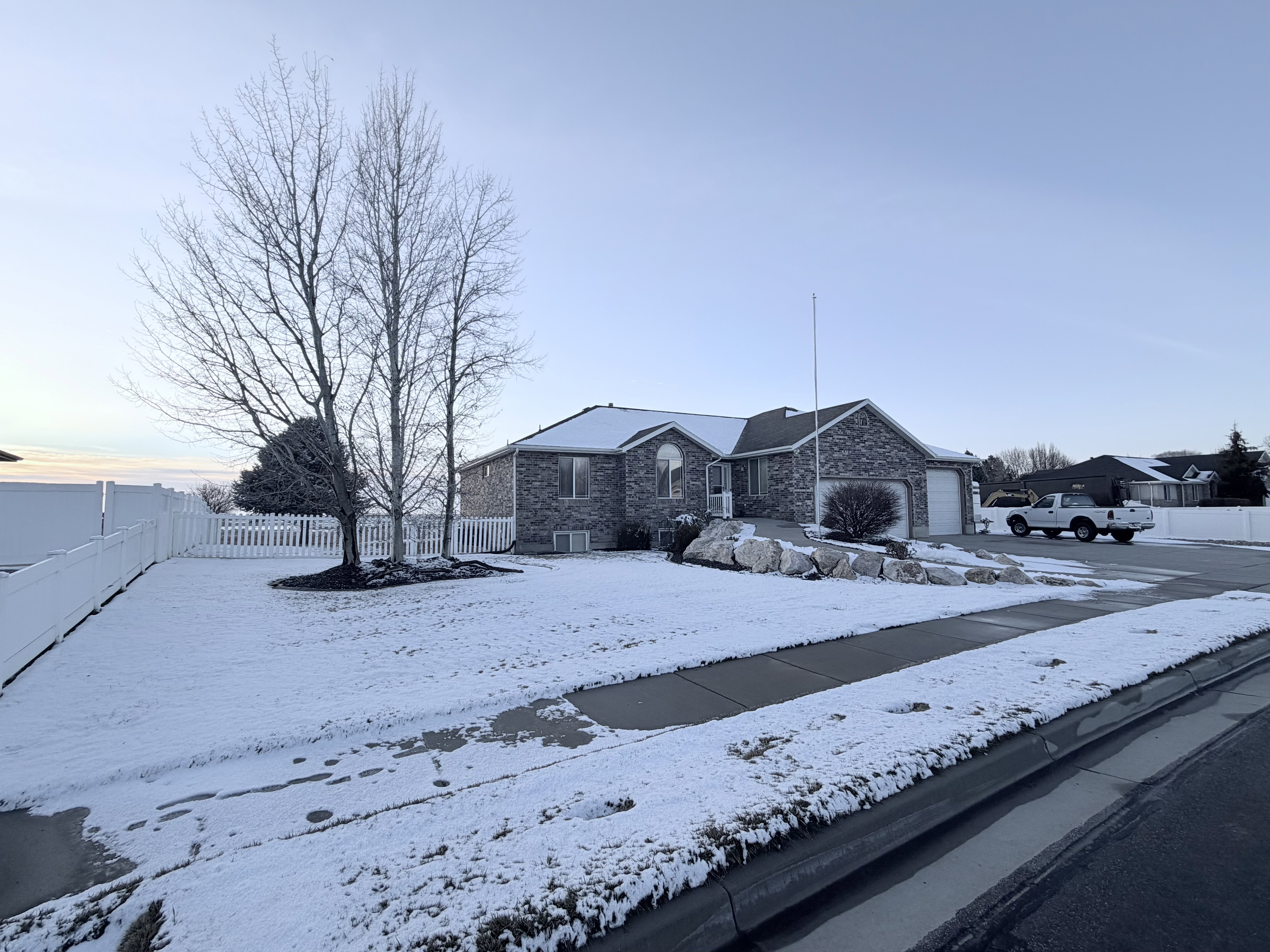 Ranch-style house featuring stone siding and an attached garage