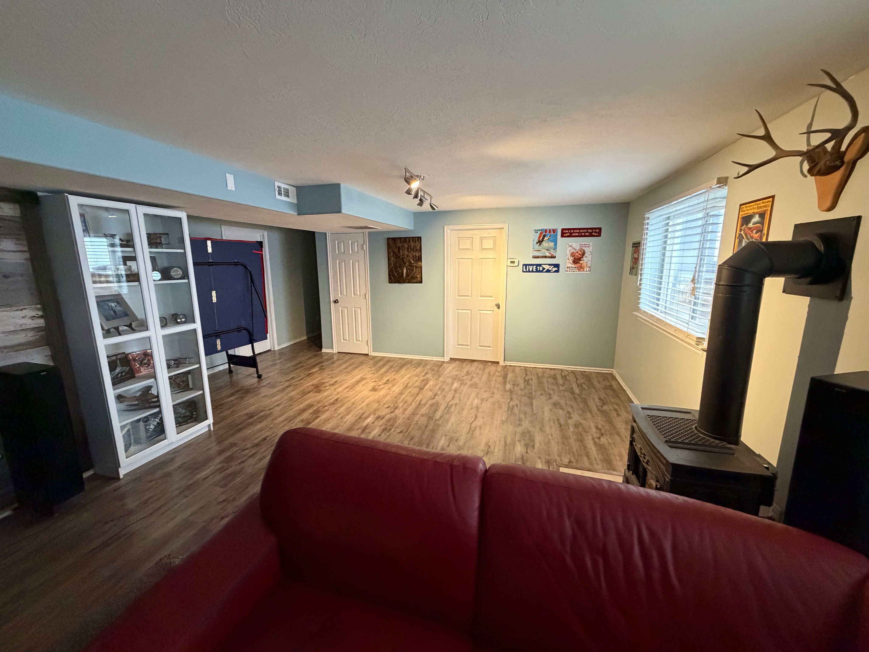 Living area with wood finished floors and a wood stove