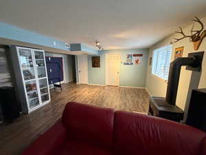 Living area with wood finished floors and a wood stove
