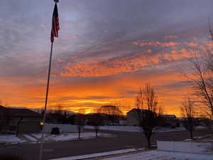 View of asphalt road with a residential view and sidewalks