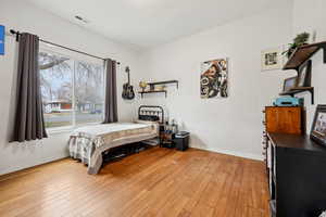 Bedroom featuring baseboards and light wood-style flooring