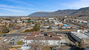 Aerial view of property and surrounding area featuring mountains
