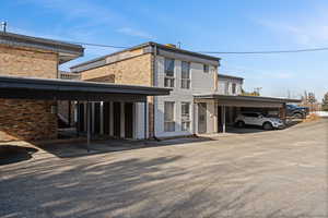 View of side of home with brick siding and covered parking