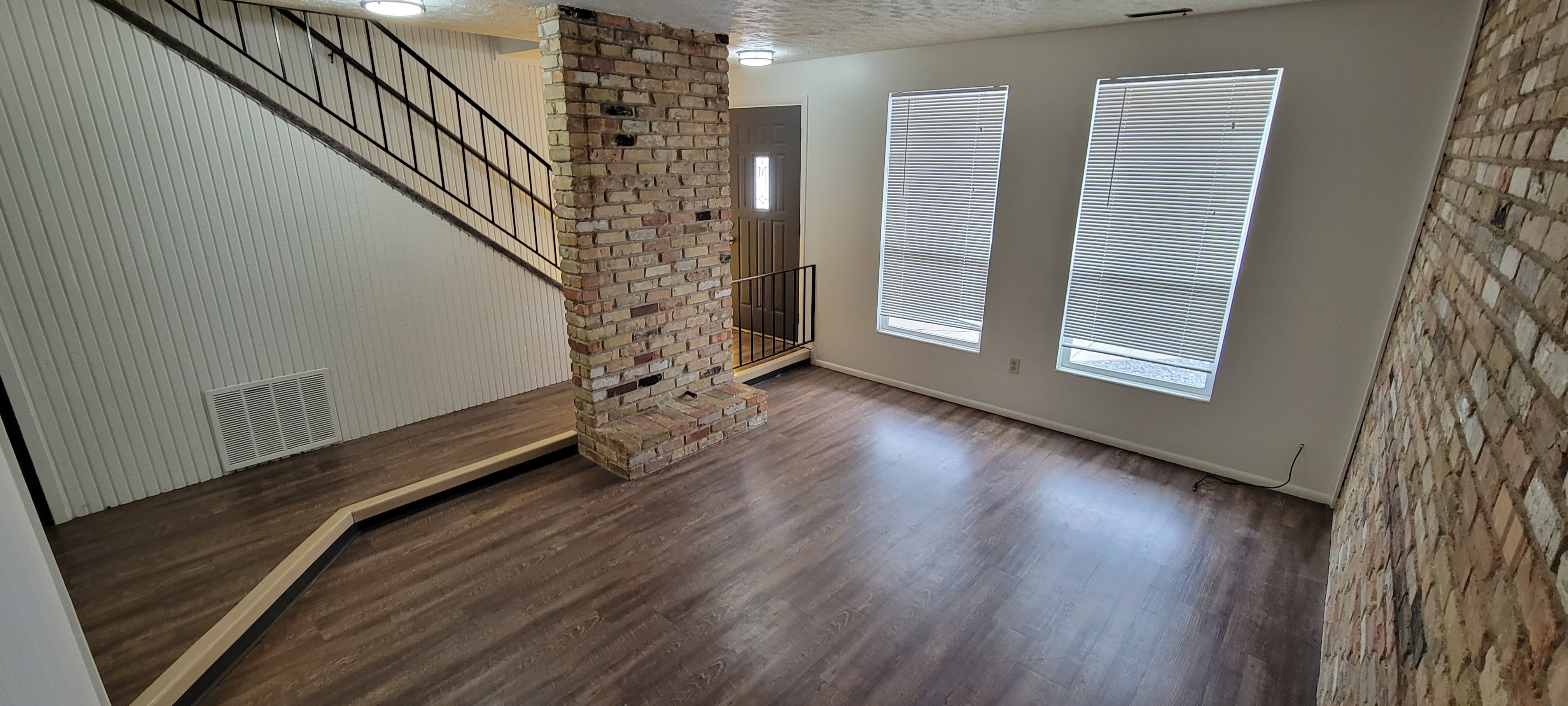 Unit #4-Entryway featuring a textured ceiling, stairway, and wood finished floors