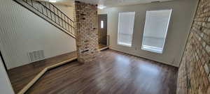 Unit #4-Entryway featuring a textured ceiling, stairway, and wood finished floors