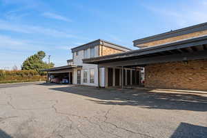 View of property with covered parking