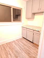 Kitchen featuring light wood-type flooring and light countertops