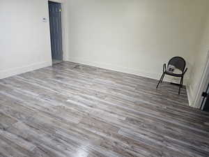 Empty room with light wood-type flooring and baseboards