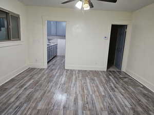 Empty room featuring light wood-style floors and a ceiling fan