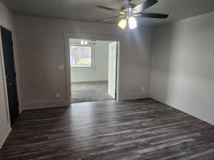 Spare room with ceiling fan and dark wood finished floors