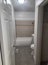 Bathroom featuring tile patterned flooring, vanity, and shower / bathtub combination