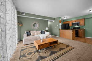 Living room with light colored carpet and light tile patterned floors
