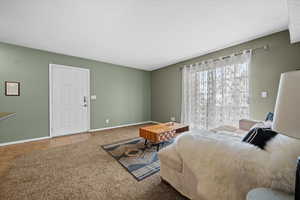 Tiled bedroom with carpet flooring and baseboards
