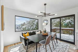 Dining area with light wood-type flooring and a chandelier