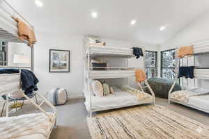 Bedroom featuring carpet, recessed lighting, and lofted ceiling