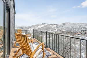 Snow covered back of property featuring a mountain view