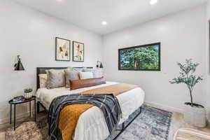 Bedroom with wood finished floors and recessed lighting