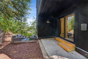 Doorway to property featuring a patio area and outdoor lounge area