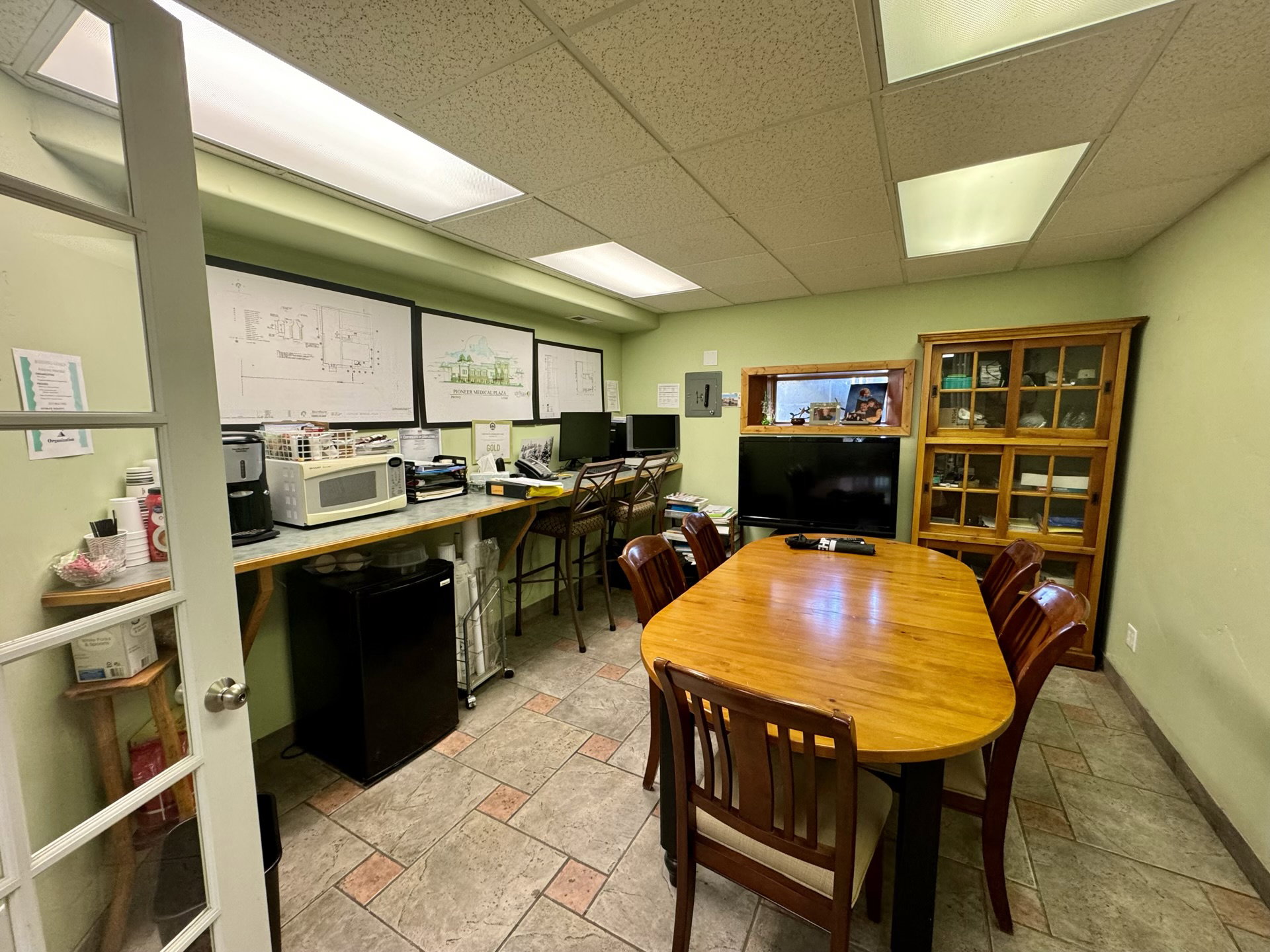 Office area featuring a paneled ceiling and built in desk