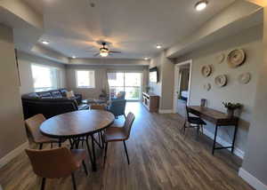 Dining area featuring wood finished floors, ceiling fan, and recessed lighting