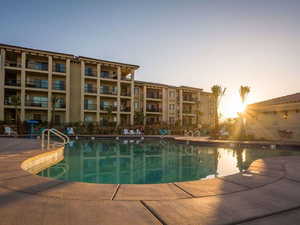 Community pool featuring a patio