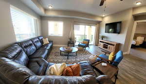 Living room featuring wood finished floors, plenty of natural light, and a ceiling fan