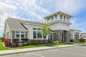 View of building exterior with uncovered parking