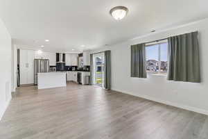 Unfurnished living room featuring light wood-style floors and recessed lighting