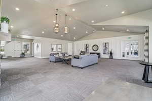 Living room featuring carpet, french doors, recessed lighting, and lofted ceiling