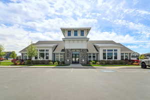 View of building exterior with uncovered parking