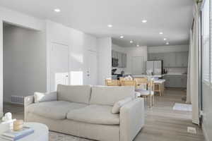 Living room featuring recessed lighting and light wood finished floors