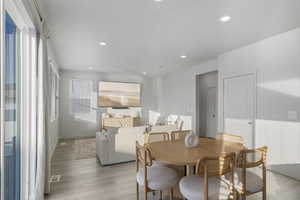 Dining space with light wood-type flooring and recessed lighting