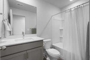 Full bathroom with shower / bath combination with curtain and vanity