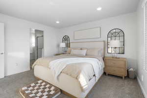 Carpeted bedroom featuring connected bathroom and recessed lighting