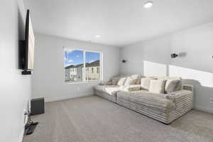 Living room featuring light carpet and a textured ceiling