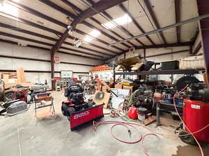 .92 Acre. Detached studio guest house 896 sq ft. $1800/month immediate income to help off set the mortgage 40x60 heated workshop with a 18' door. Outdoor pool. View of property location featuring property boundaries highlighted and a pool