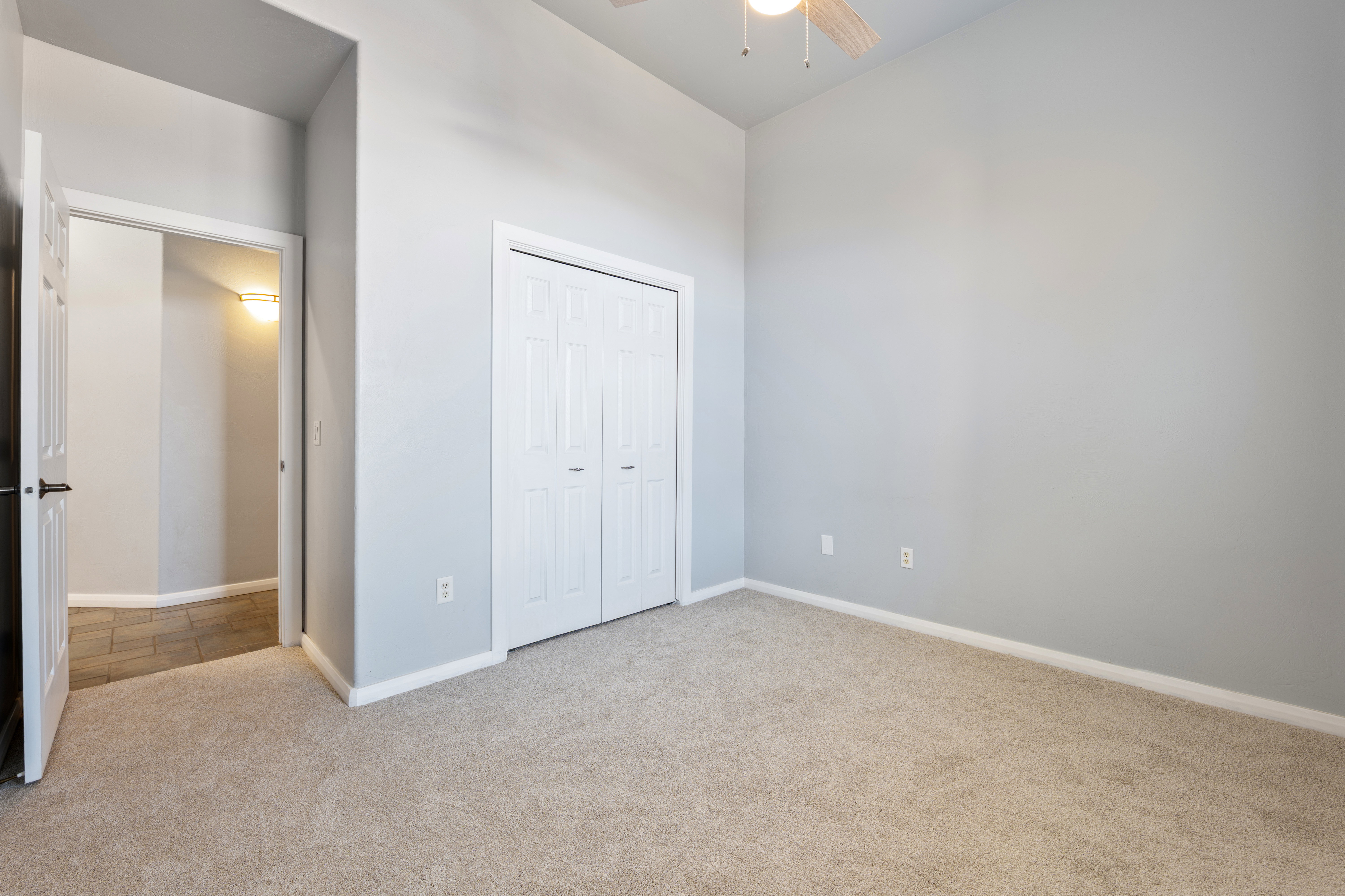 Unfurnished bedroom with carpet floors, a closet, and ceiling fan