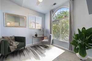 Sitting room with carpet floors, an office area, and a ceiling fan
