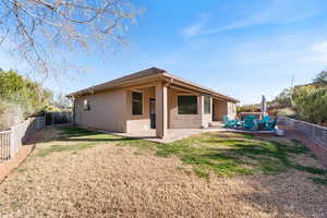 Back of property with a patio, a fenced backyard, and stucco siding