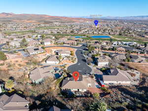 Aerial overview of property's location featuring a water and mountain view and nearby suburban area