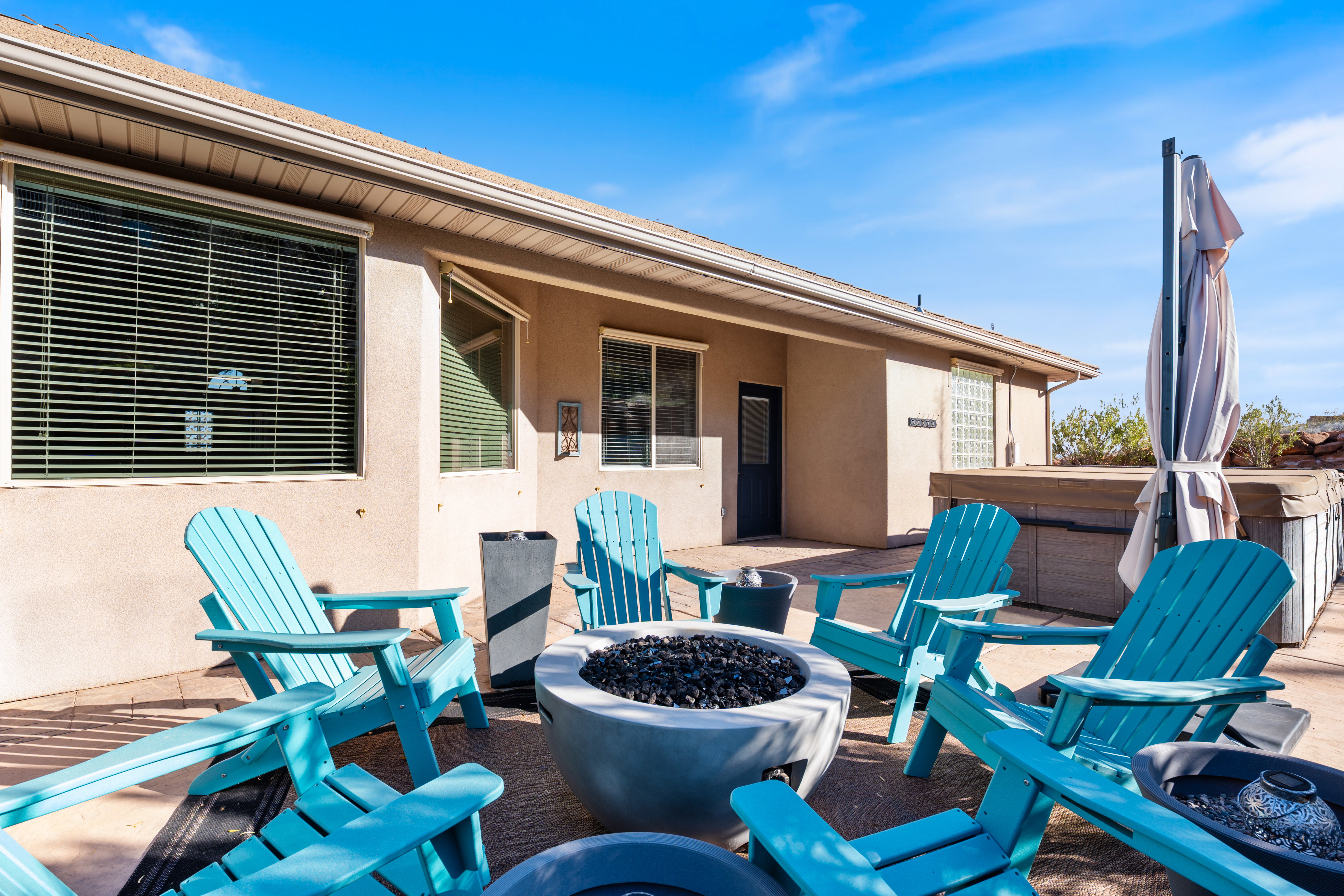 View of patio / terrace featuring an outdoor fire pit and a hot tub