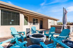 View of patio / terrace featuring an outdoor fire pit and a hot tub