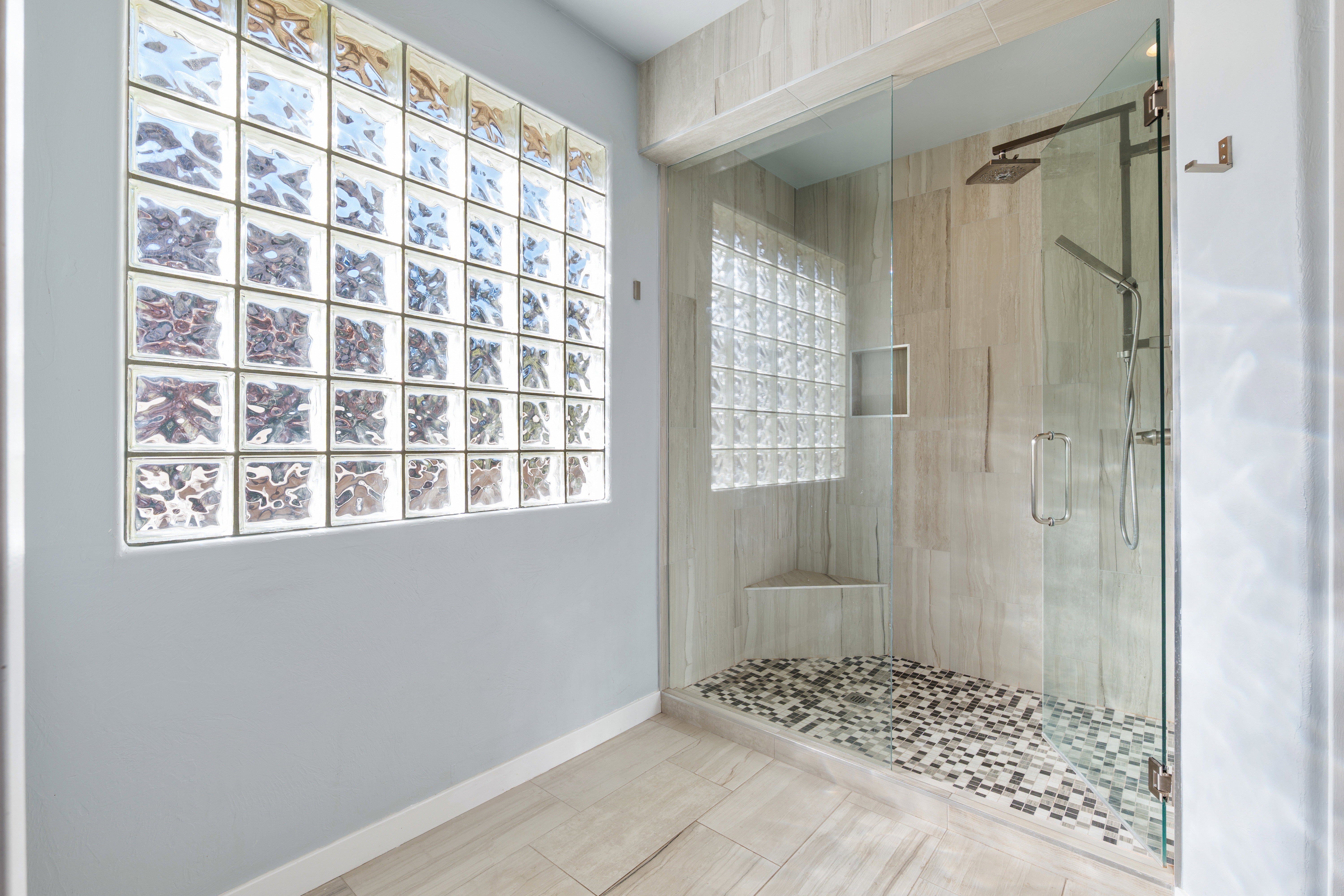 Bathroom featuring baseboards and a stall shower