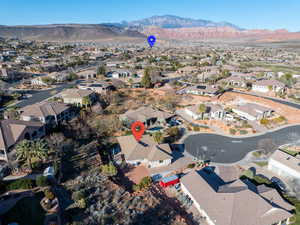 Aerial view of property's location featuring a mountain backdrop and nearby suburban area
