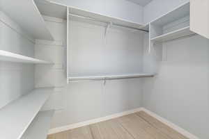 Walk in closet featuring light wood-style flooring