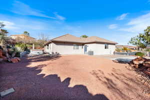 Rear view of house with stucco siding and a tile roof